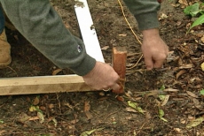 tying string to the first corner stake