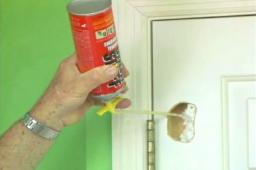 filling the hole in the door with aerosol foam insulation