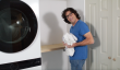 Man at doing laundry on shelf 