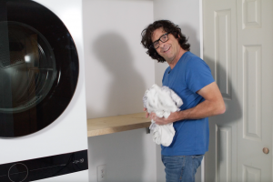 Man at doing laundry on shelf 