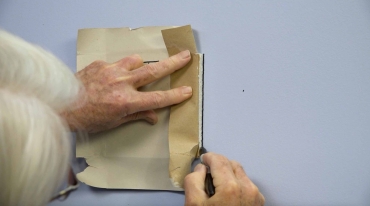 Man-holds-a-piece-of-cut-drywall